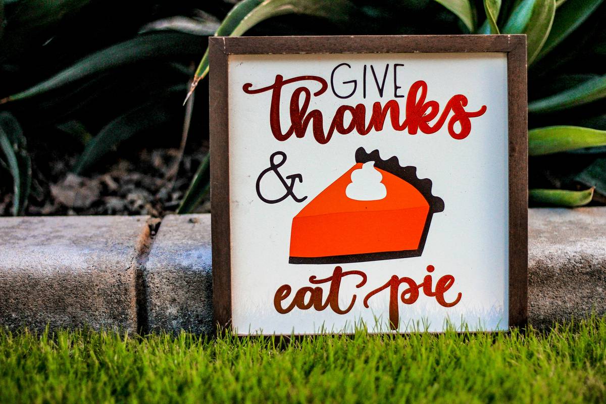 thanksgiving decor ideas diy featuring a rustic table centerpiece with pumpkins, candles, and eucalyptus